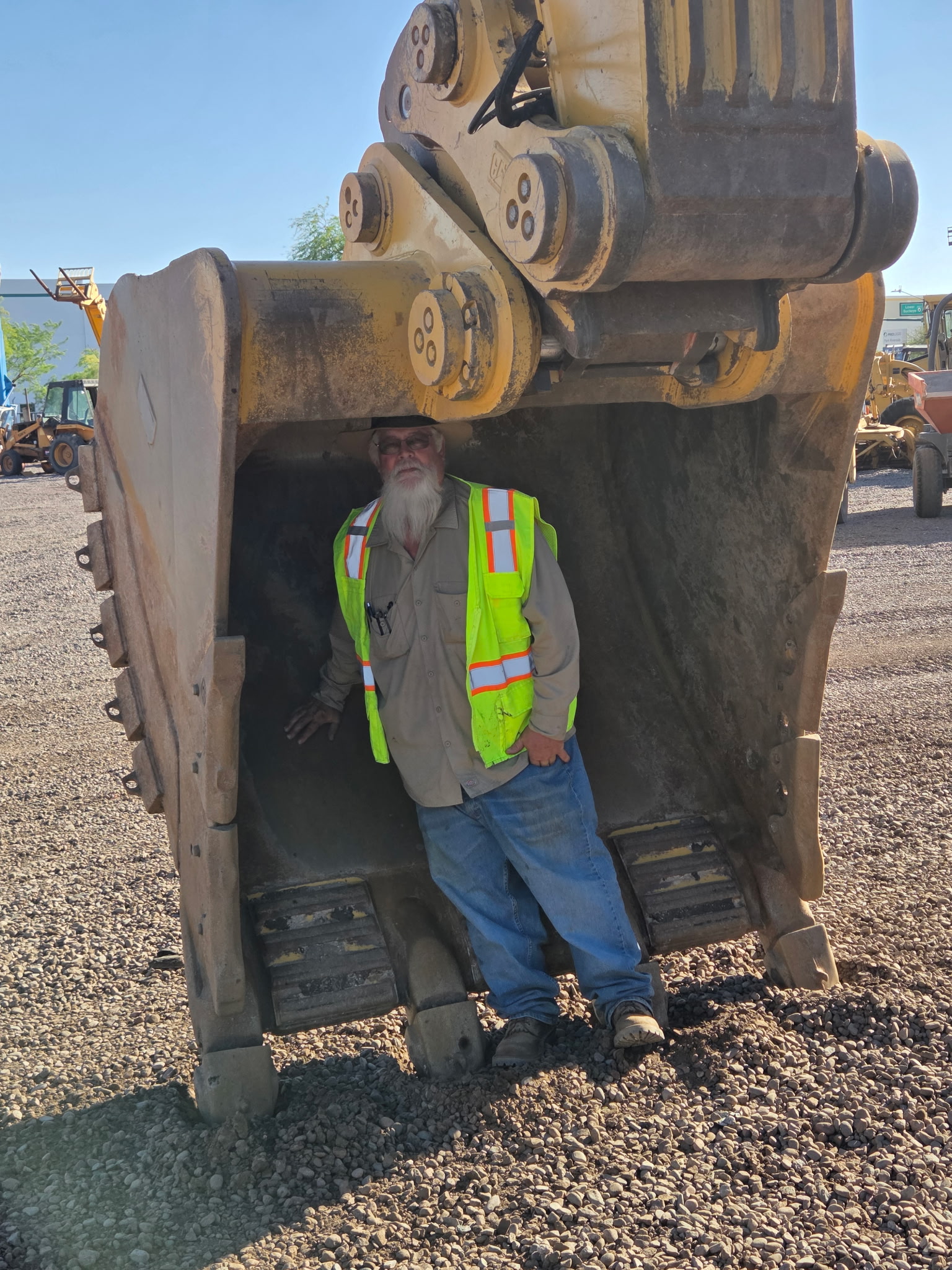 Standing in the excavator bucket at sunset