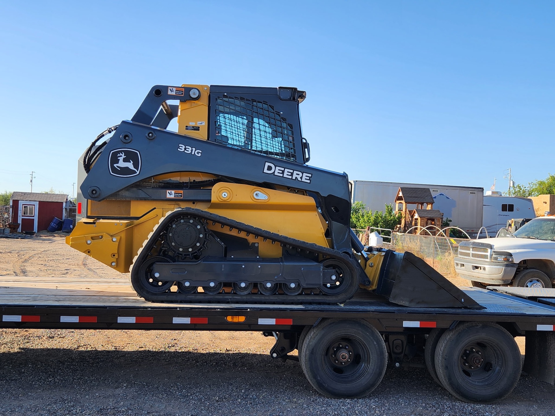 John Deere 331G compact track loader profile on trailer