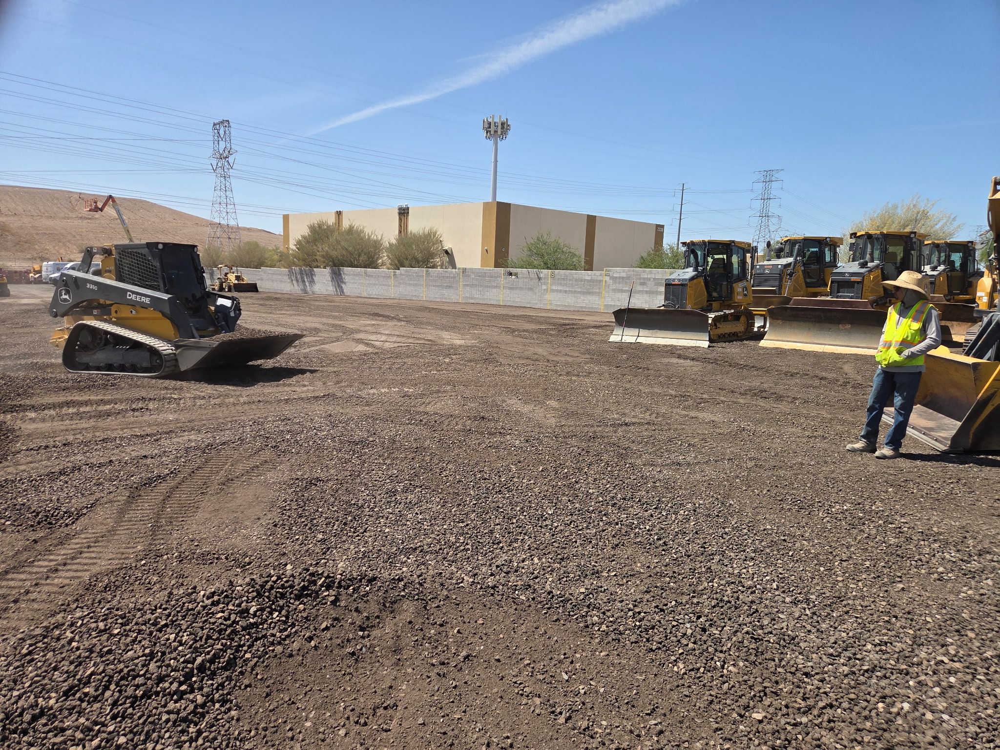 Skid steer and backhoe working the same jobsite