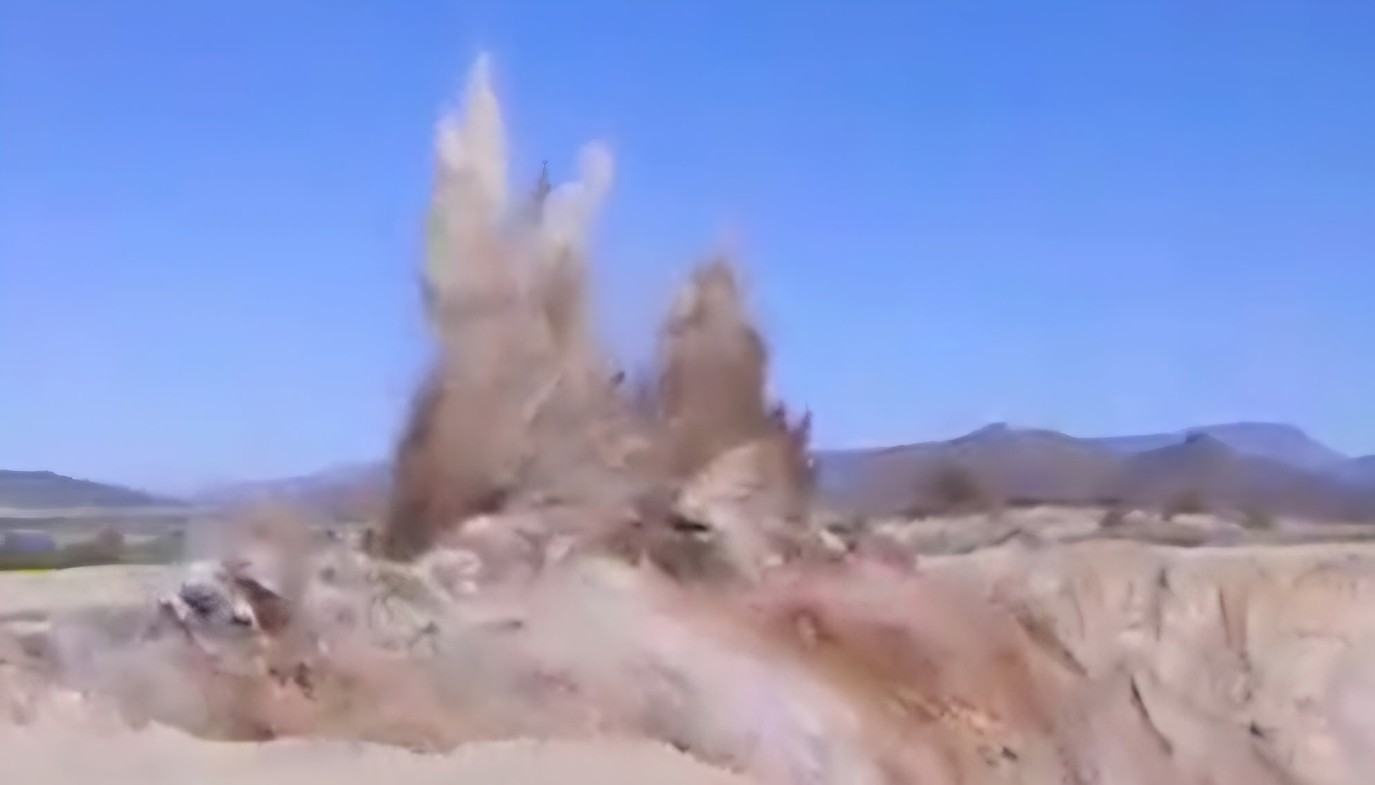 Controlled rock blast on an Arizona jobsite