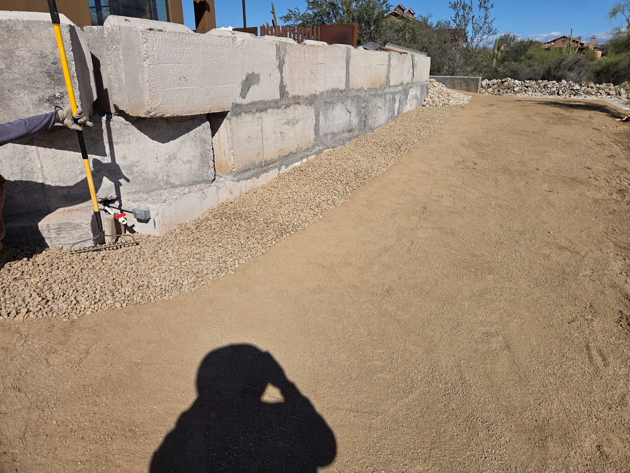 Finished retaining block wall along a graded driveway