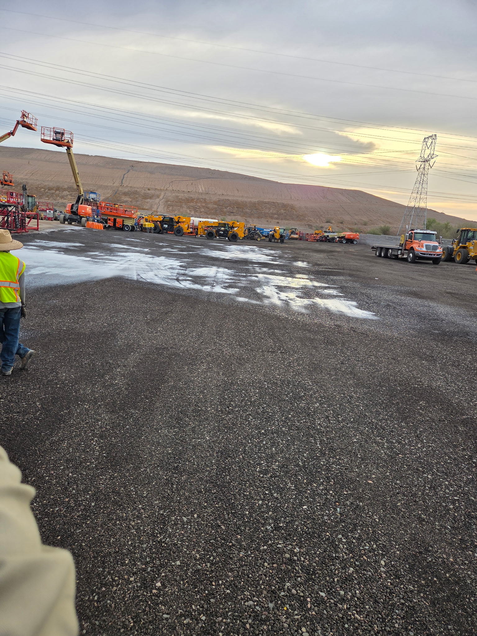 Sunset over a freshly paved asphalt lot