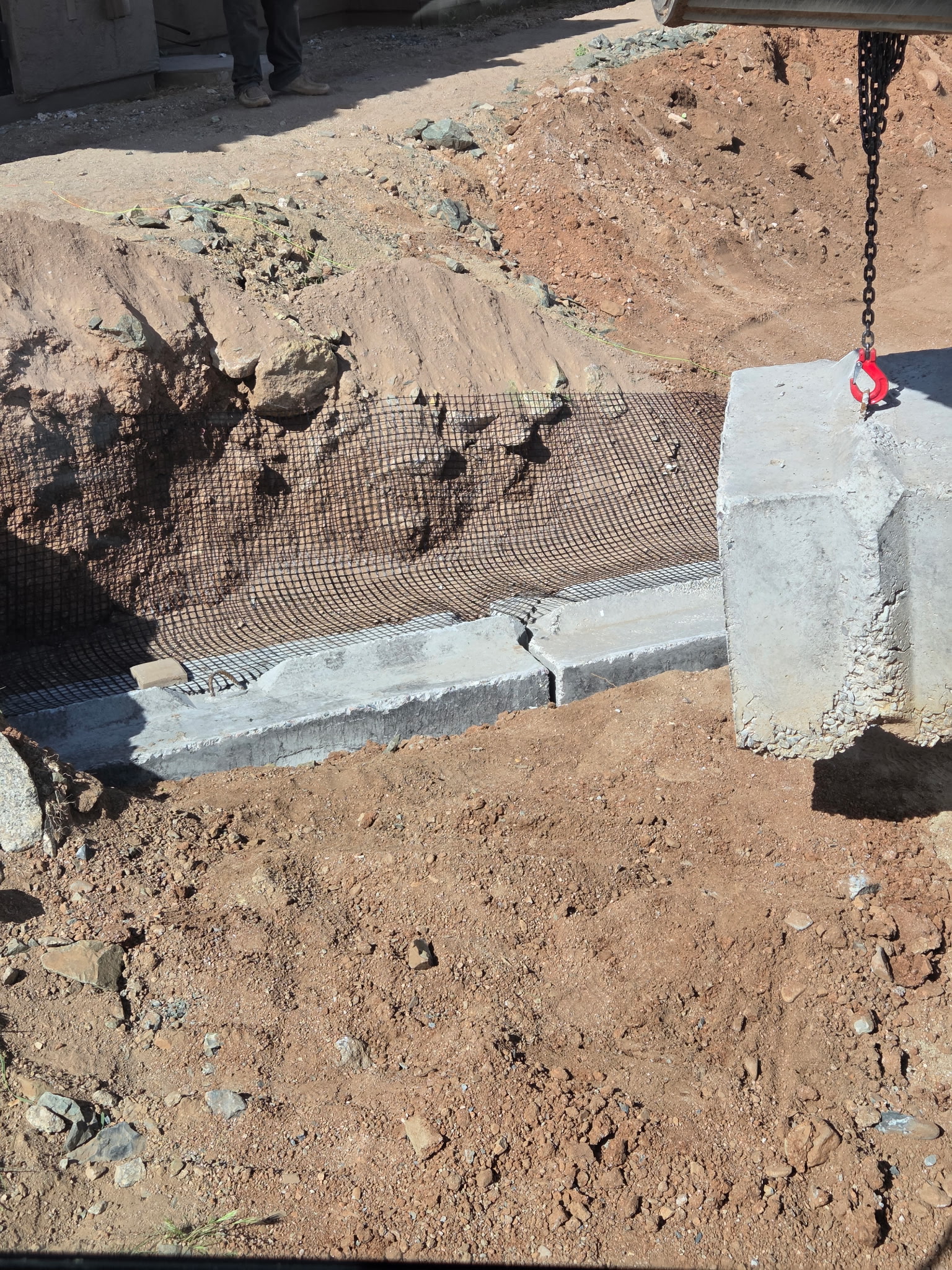 Setting large precast concrete barrier blocks