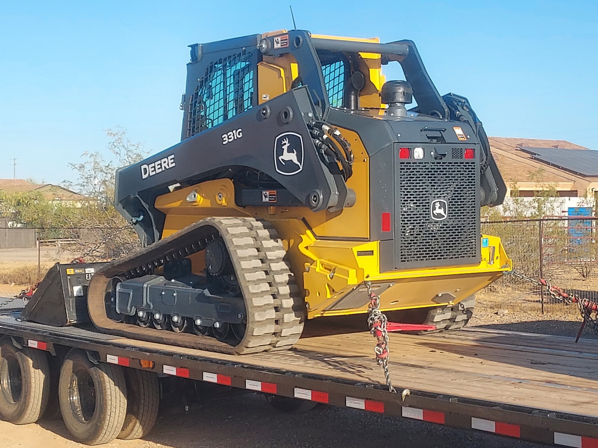 John Deere 331G compact track loader on a lowboy trailer