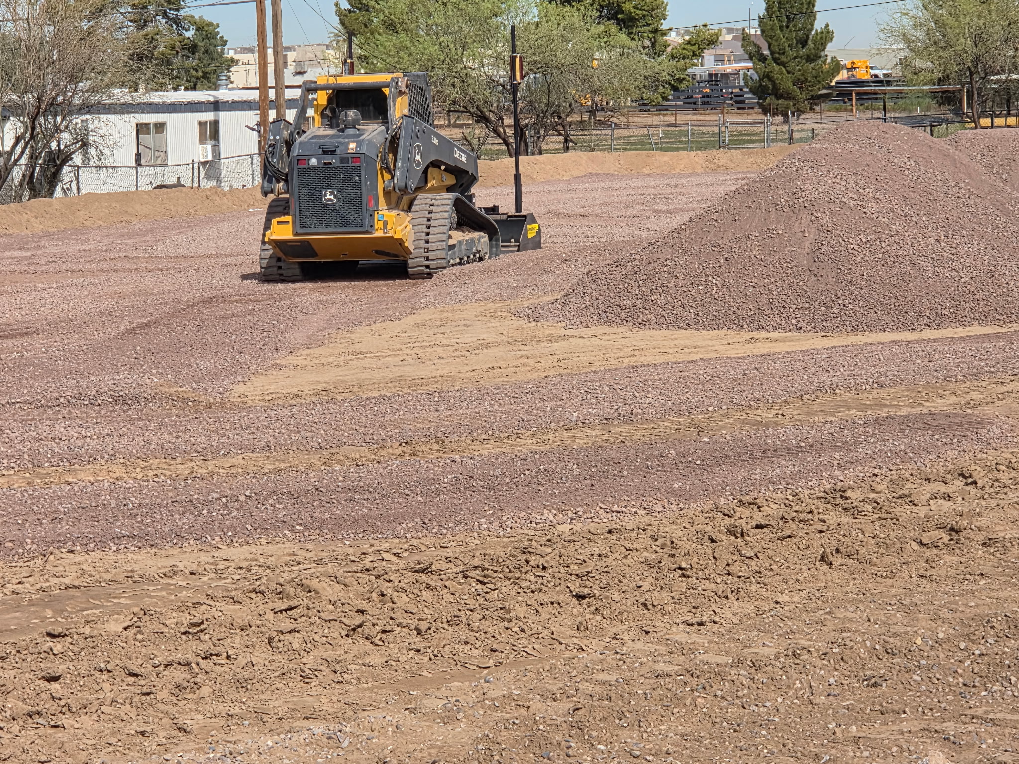 Skid steer working a fresh gravel pad