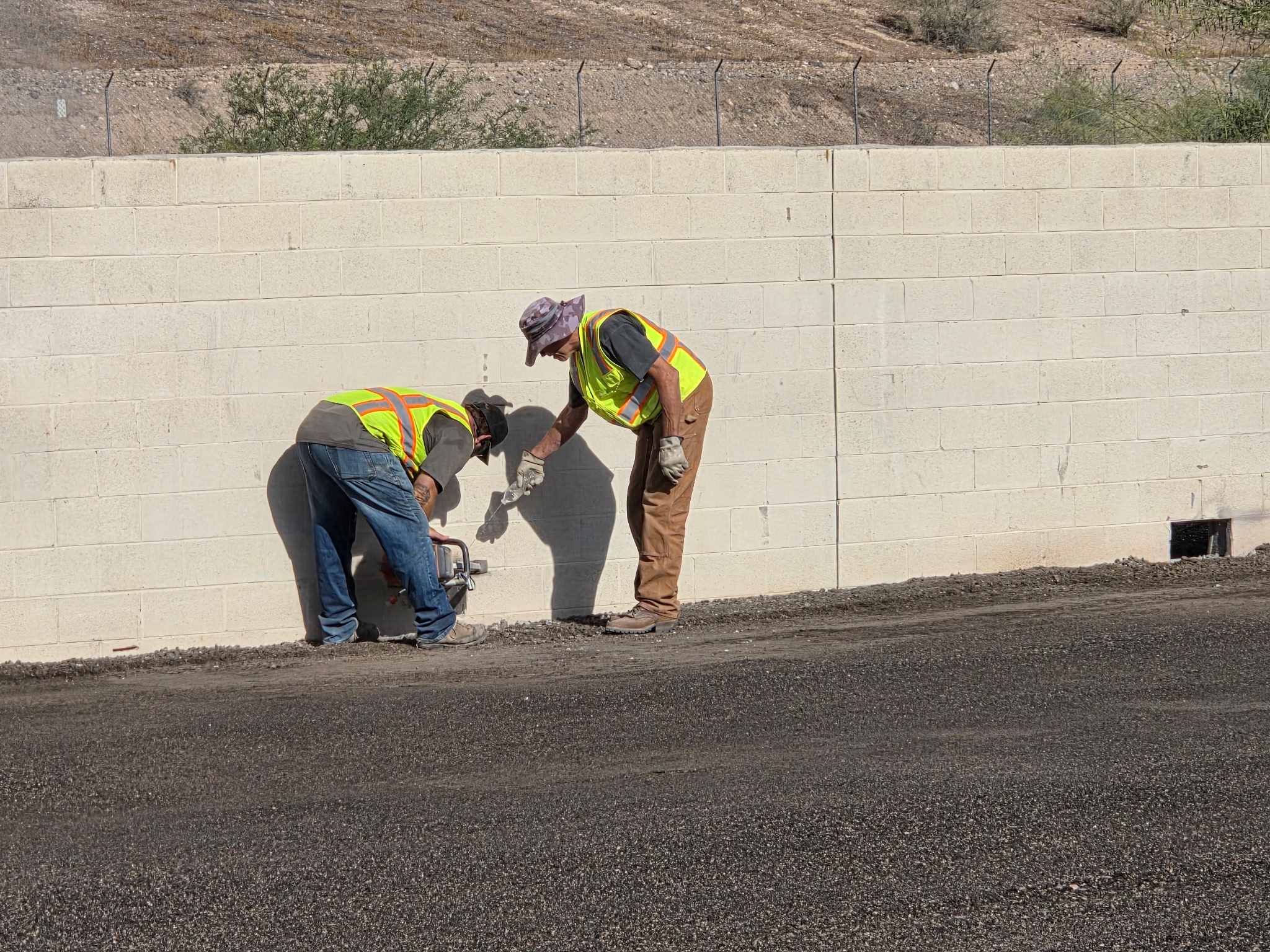 Crew handling detail work at a block wall